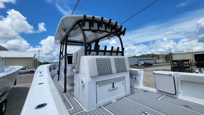 Slide: The Image of 2023 Front Runner 39 CC boat with sleek deck and rod holders under a blue sky. - 20