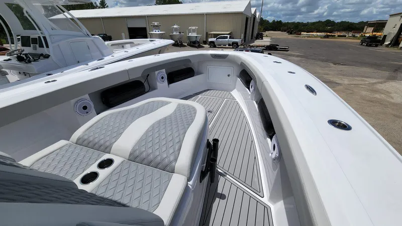 Slide: The Image of 2023 Front Runner 39 CC boat interior with gray seating and deck, docked outdoors. - 22