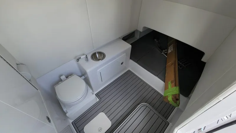 Slide: The Image of 2023 Front Runner 39 CC boat interior with toilet and sink, featuring modern design and wood flooring. - 23