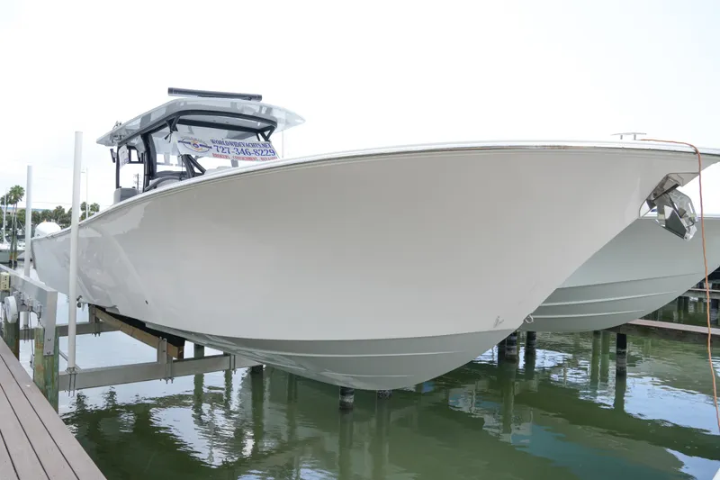 Slide: The Image of 2023 Front Runner 39 CC boat docked on water, showcasing sleek design and modern features. - 5