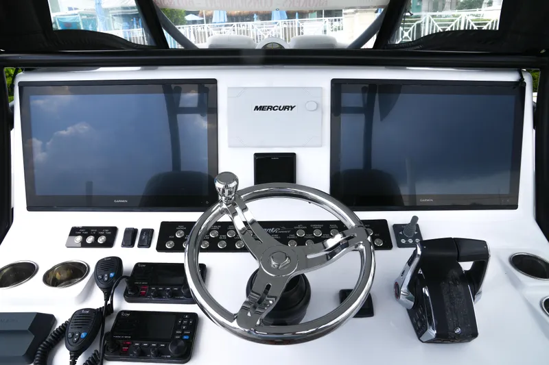 Slide: The Image of 2023 Front Runner 39 CC boat dashboard with dual screens and Mercury controls. - 7