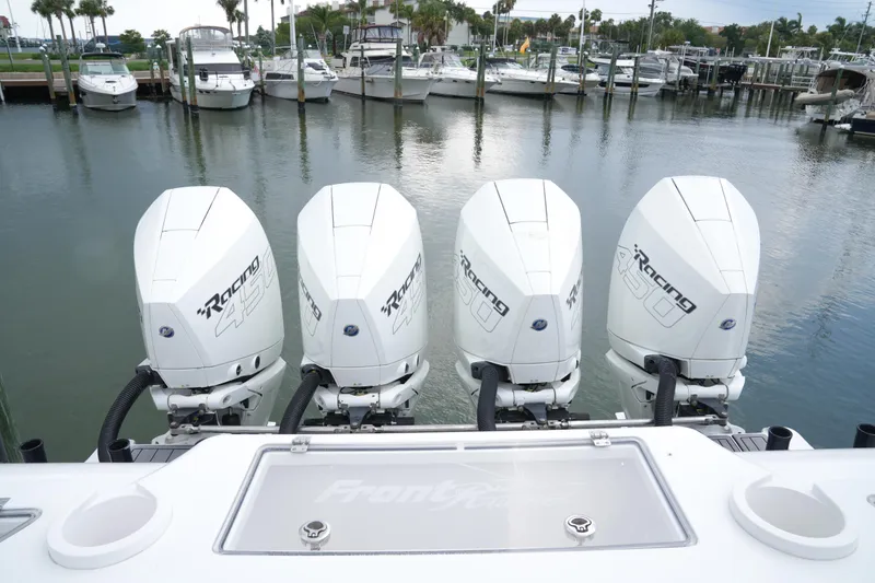 Slide: The Image of 2023 Front Runner 39 CC boat with four powerful outboard engines docked at marina. - 8
