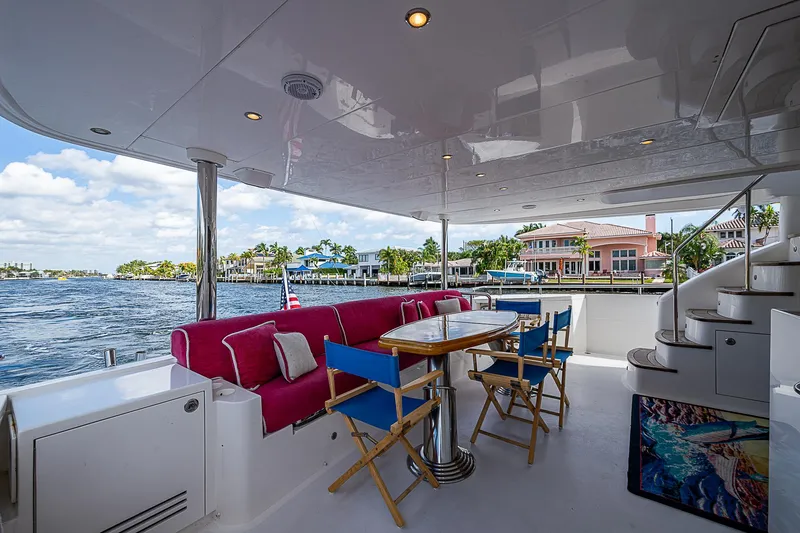 Slide: The Image of Luxurious 2013 Johnson 78 Cockpit Motoryacht with spacious outdoor seating and scenic waterfront view. - 1