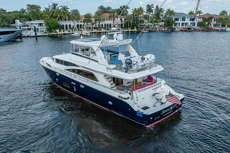 Slide: The Image of 2013 Johnson 78 Cockpit Motoryacht cruising on a scenic waterway. - 11