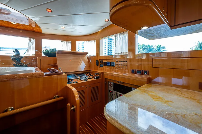 Slide: The Image of Luxurious interior of a 2013 Johnson 78 Cockpit Motoryacht with polished wood and modern controls. - 26