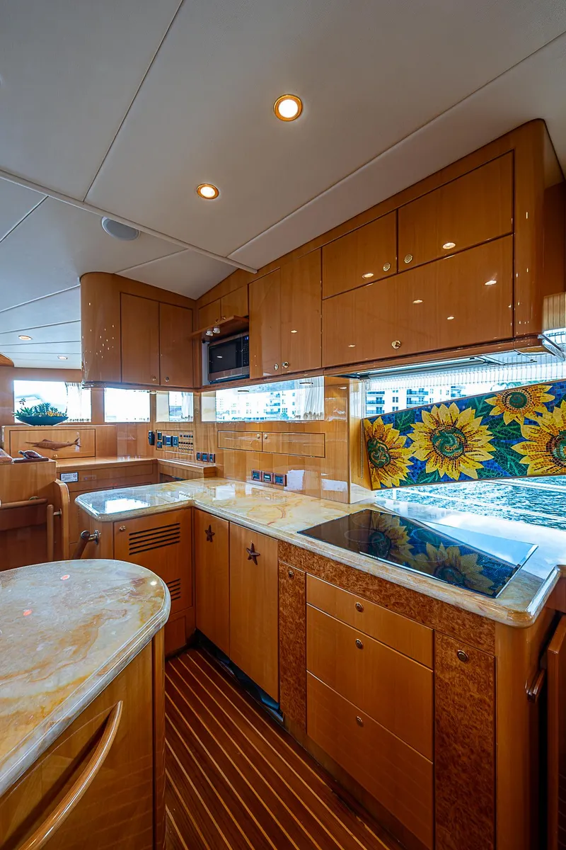 Slide: The Image of Luxurious kitchen interior of 2013 Johnson 78 Cockpit Motoryacht with sunflower backsplash. - 27