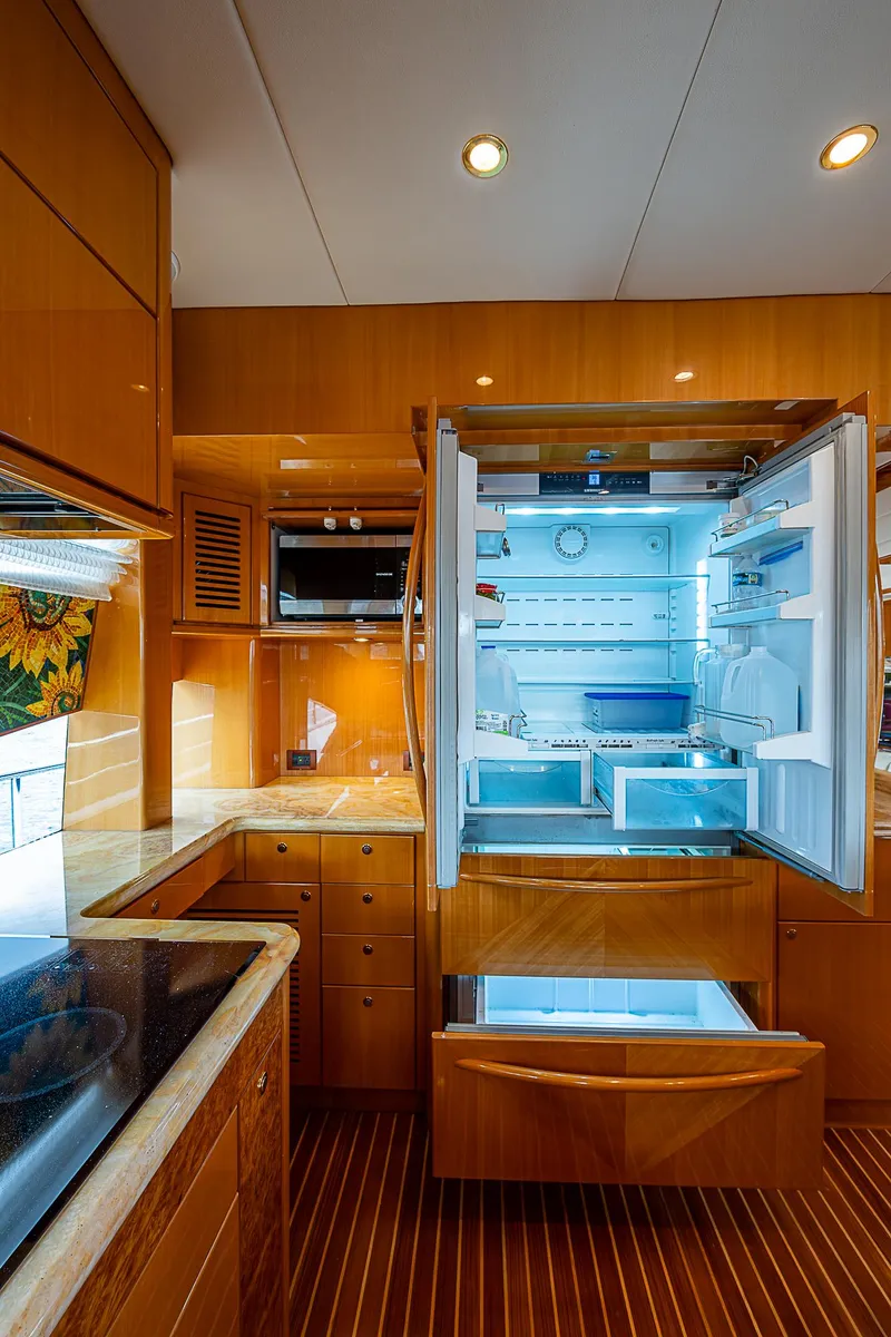 Slide: The Image of Luxurious kitchen interior of 2013 Johnson 78 Cockpit Motoryacht with open refrigerator. - 28