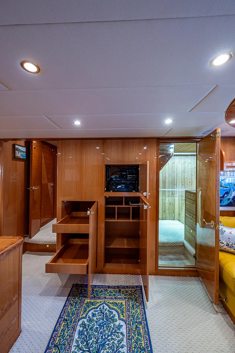 Slide: The Image of Interior of 2013 Johnson 78 Cockpit Motoryacht with wooden cabinetry and carpeted flooring. - 36