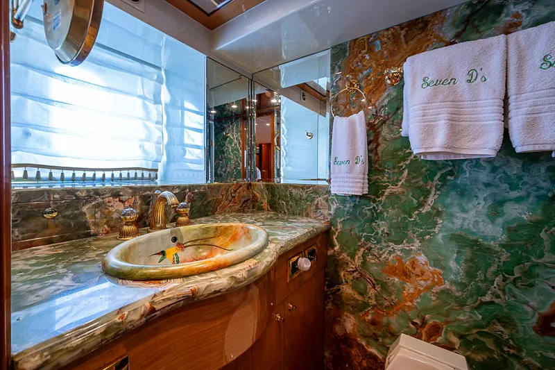 Slide: The Image of Luxurious bathroom in 2013 Johnson 78 Cockpit Motoryacht with marble sink and elegant decor. - 38