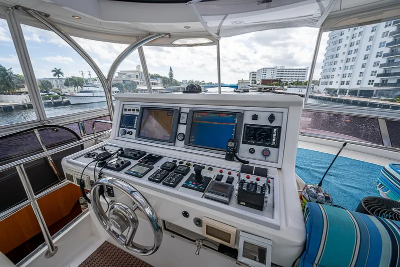 Slide: The Image of Cockpit of 2013 Johnson 78 Motoryacht with navigation controls and waterfront view. - 4