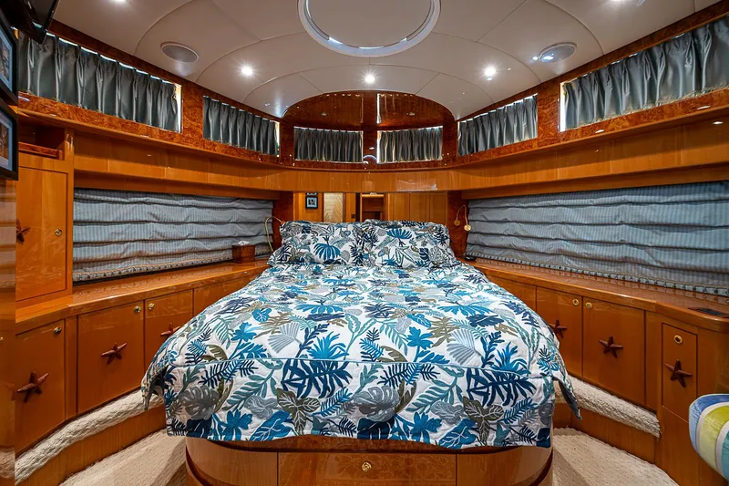 Slide: The Image of Luxurious bedroom interior of 2013 Johnson 78 Cockpit Motoryacht with elegant wood finish and patterned bedding. - 44