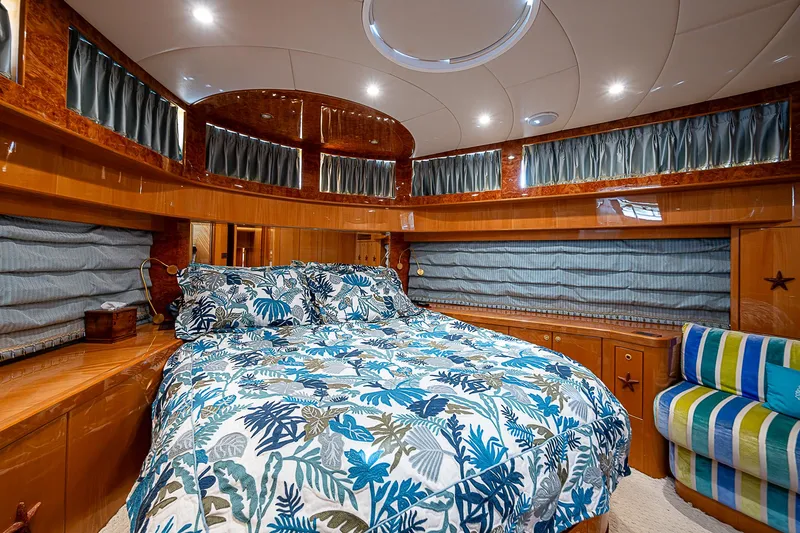 Slide: The Image of Luxurious bedroom in 2013 Johnson 78 Cockpit Motoryacht with floral bedding and wood accents. - 46