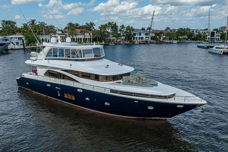 Slide: The Image of Johnson 78 Cockpit Motoryacht 2013 cruising on a scenic waterway with palm trees. - 6