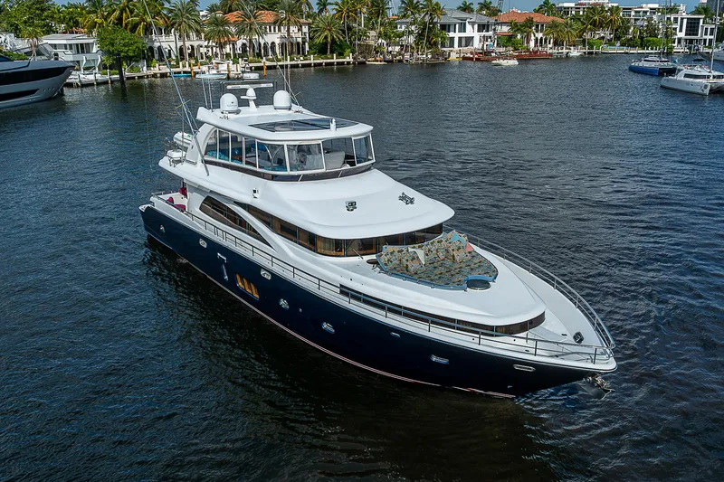 Slide: The Image of 2013 Johnson 78 Cockpit Motoryacht cruising on a serene waterway. - 7