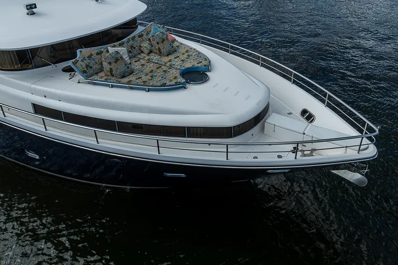 Slide: The Image of Johnson 78 Cockpit Motoryacht 2013 on water, featuring spacious deck and sleek design. - 8