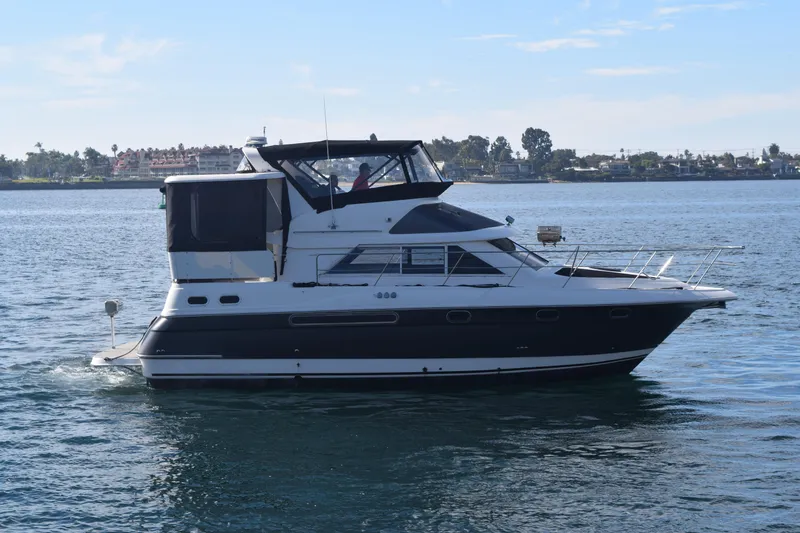 Slide: The Image of 1995 Cruisers Yachts 3650 ACMY on calm water, side view. - 0