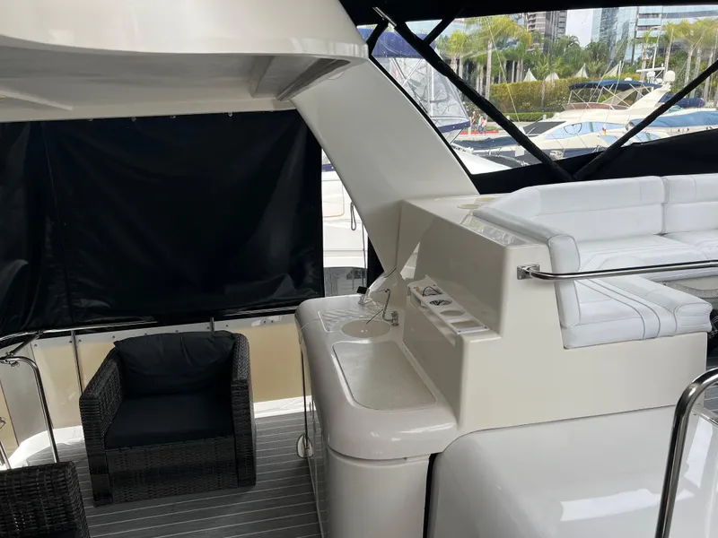 Slide: The Image of 1995 Cruisers Yachts 3650 ACMY interior with seating and sink, docked at marina. - 22