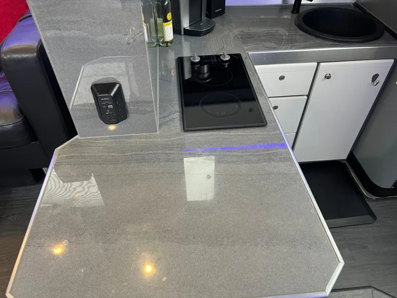 Slide: The Image of 1995 Cruisers Yachts 3650 ACMY kitchen area with sleek countertop and modern appliances. - 53