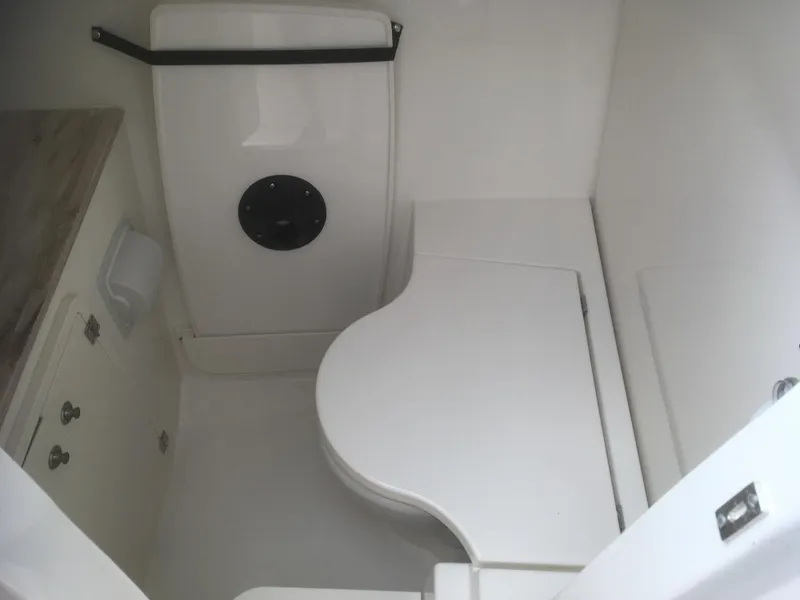 Slide: The Image of 2025 Pursuit DC 326 Dual Console boat interior, featuring a compact, modern bathroom space. - 3