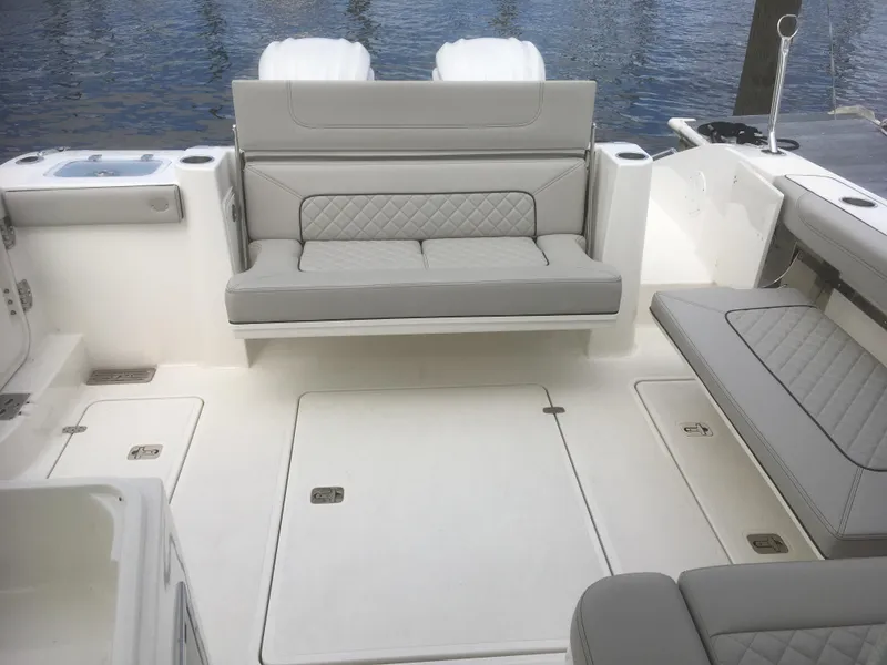 Slide: The Image of 2025 Pursuit DC 326 Dual Console boat interior with cushioned seating and sleek design. - 5