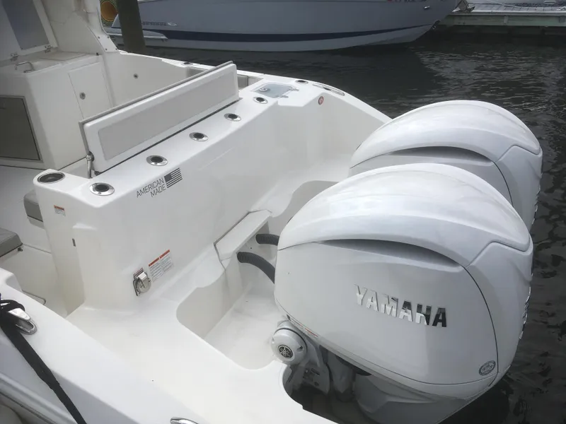 Slide: The Image of 2025 Pursuit DC 326 Dual Console with twin Yamaha outboard engines, docked on water. - 6