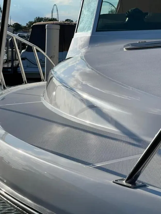 Slide: The Image of 1999 Tiara Yachts 4100 Open, sleek deck design, docked at marina. - 11