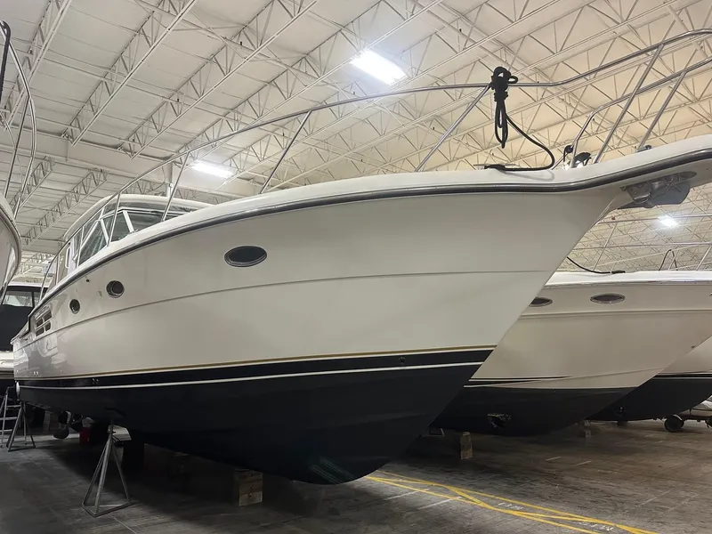 Slide: The Image of 1999 Tiara Yachts 4100 Open in indoor storage, showcasing sleek design and craftsmanship. - 12