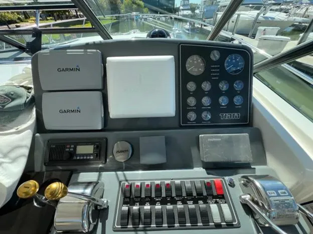 Slide: The Image of Dashboard of a 1999 Tiara Yachts 4100 Open with Garmin navigation equipment. - 18