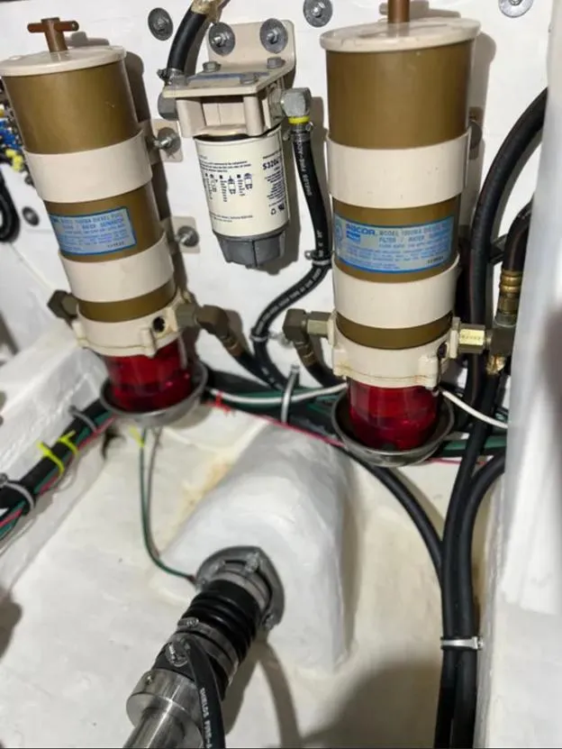 Slide: The Image of Engine compartment of a 1999 Tiara Yachts 4100 Open, showing fuel filters and wiring. - 19