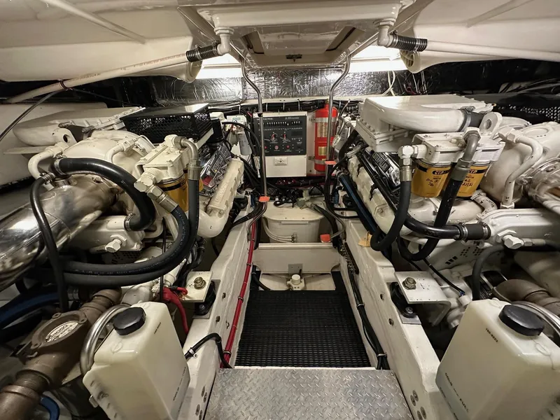 Slide: The Image of Engine room of a 1999 Tiara Yachts 4100 Open, showcasing dual engines and mechanical components. - 21