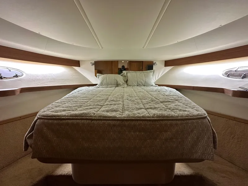 Slide: The Image of 1999 Tiara Yachts 4100 Open cabin interior with a cozy bed and elegant design. - 3