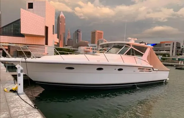 Slide: The Image of 1999 Tiara Yachts 4100 Open docked in urban marina setting. - 4