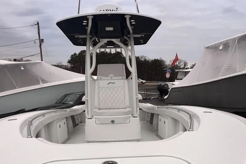 Slide: The Image of 2021 Yellowfin 26 Hybrid boat with center console and T-top, docked outdoors. - 1
