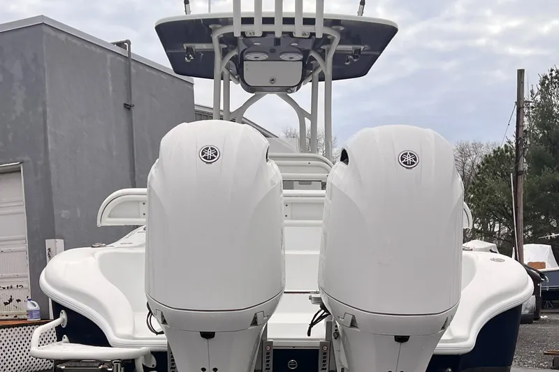 Slide: The Image of 2021 Yellowfin 26 Hybrid boat with dual outboard engines, rear view. - 2
