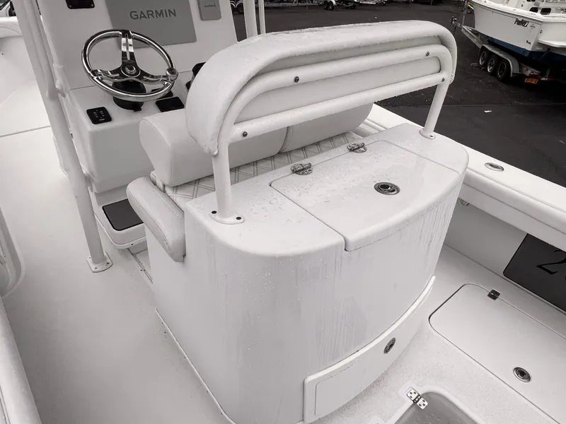 Slide: The Image of 2021 Yellowfin 26 Hybrid boat interior with Garmin system and cushioned seating. - 7