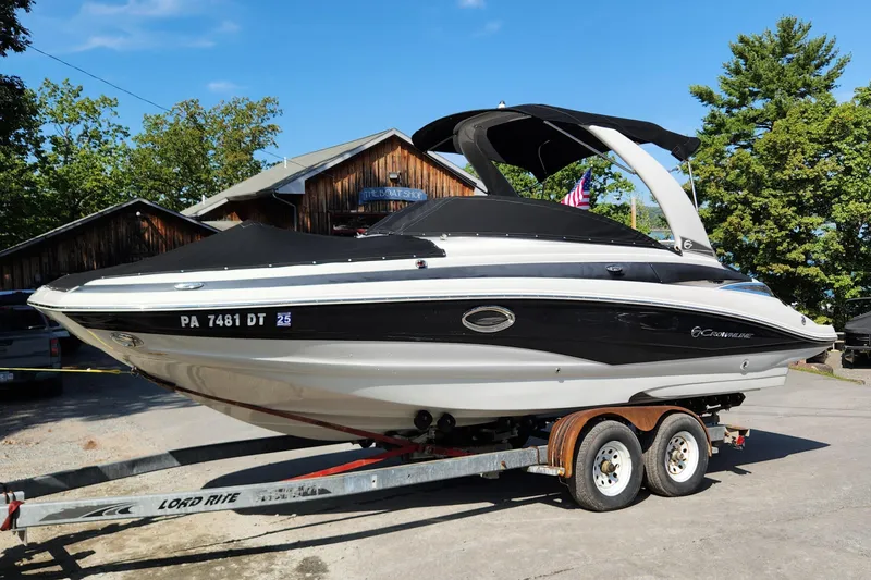 Slide: The Image of 2017 Crownline Eclipse E4 boat on trailer, black and white design, parked outdoors. - 1