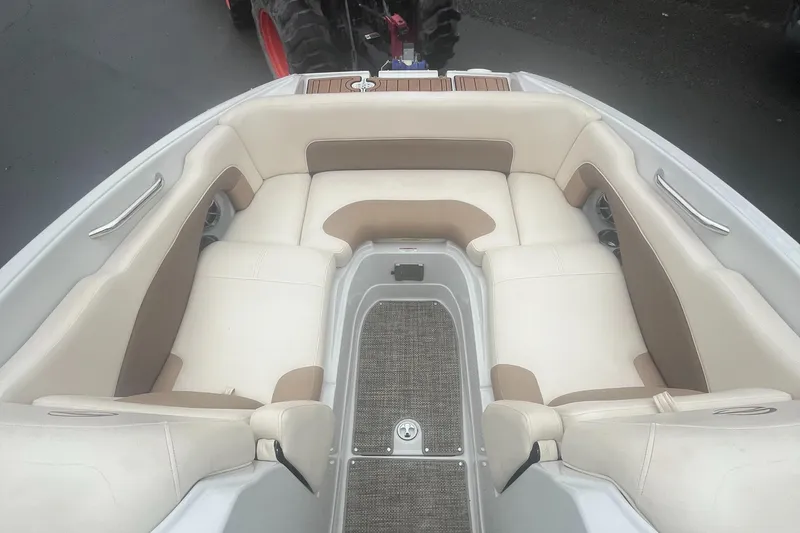 Slide: The Image of 2017 Crownline Eclipse E4 boat interior with beige seating and carpeted floor. - 11