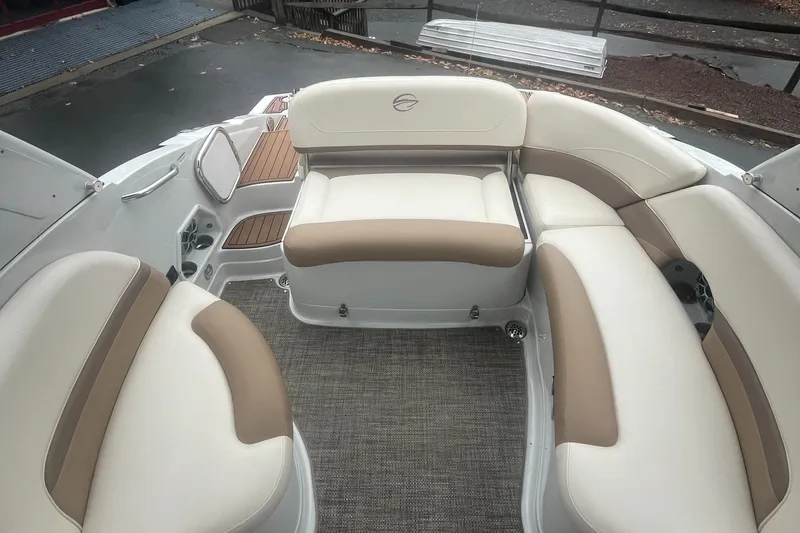 Slide: The Image of 2017 Crownline Eclipse E4 boat interior with beige and brown seating, featuring a spacious layout. - 13