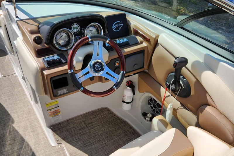Slide: The Image of 2017 Crownline Eclipse E4 boat cockpit with steering wheel, gauges, and controls. - 7