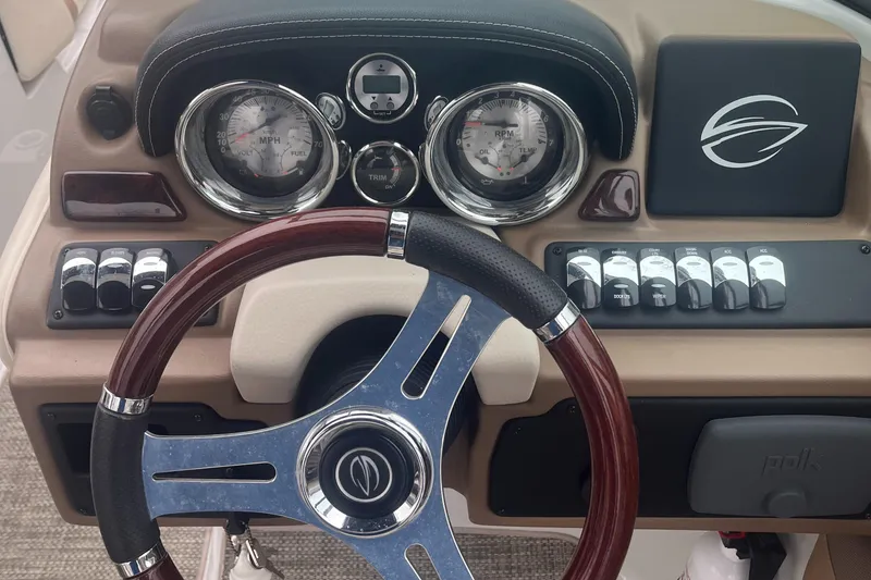 Slide: The Image of Steering wheel and dashboard of 2017 Crownline Eclipse E4 boat, featuring gauges and controls. - 8