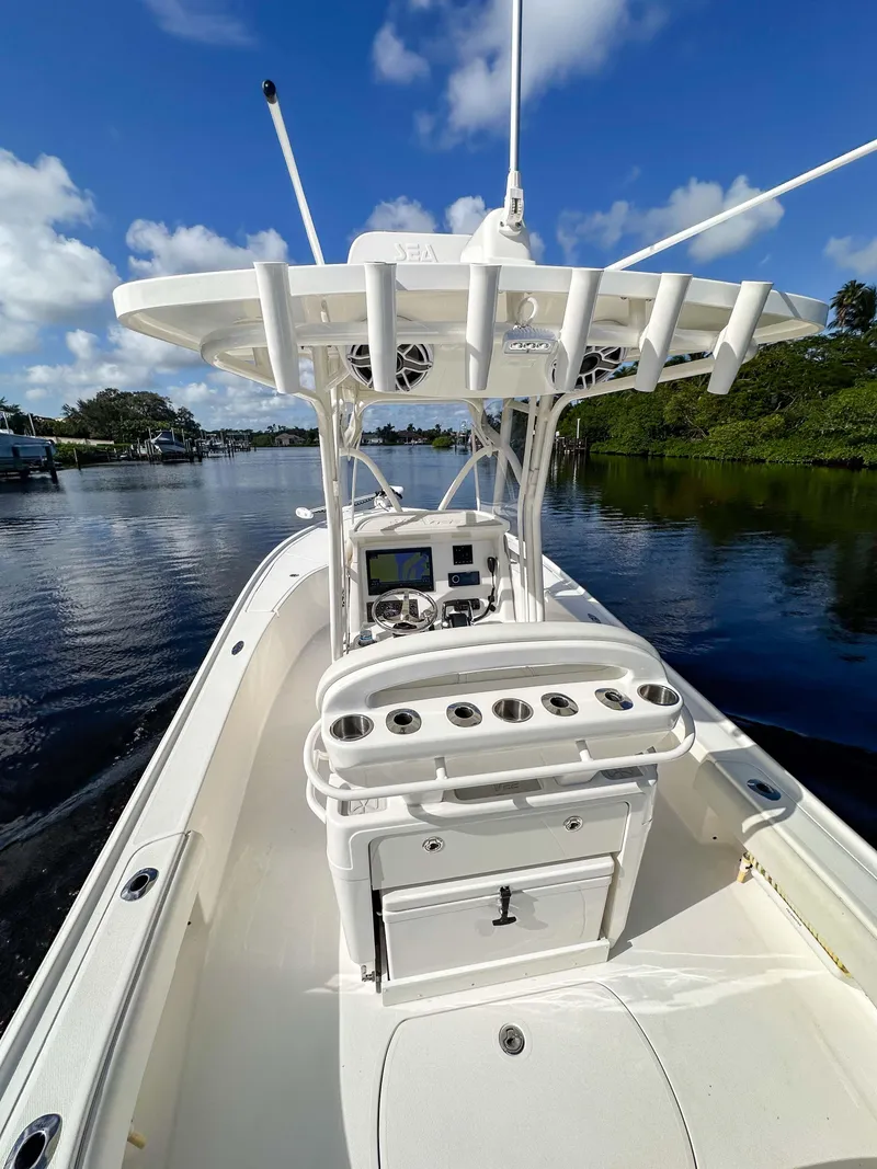 Slide: The Image of 2022 SeaVee 270Z boat on calm water, featuring a sleek console and rod holders. - 15