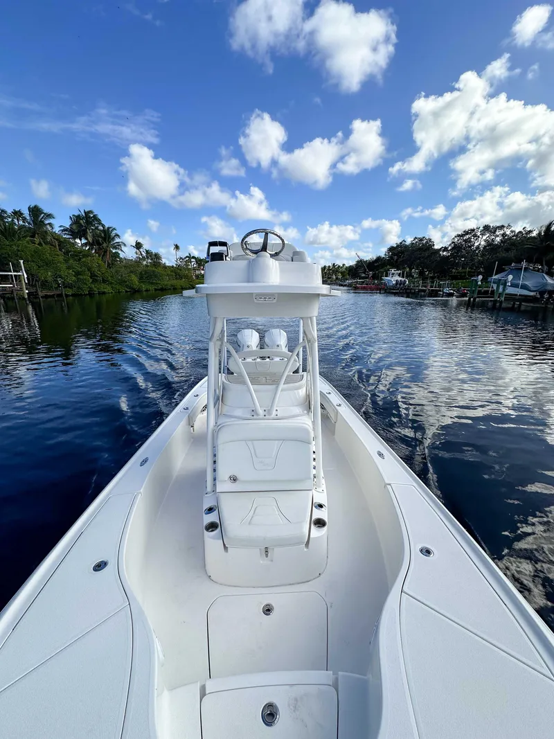 Slide: The Image of 2022 SeaVee 270Z boat on calm water under a blue sky with clouds. - 22