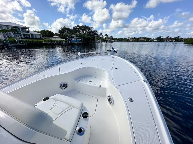 Slide: The Image of 2022 SeaVee 270Z boat on calm water under a partly cloudy sky. - 23