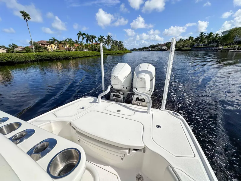 Slide: The Image of 2022 SeaVee 270Z boat on a scenic waterway with dual engines and clear skies. - 28