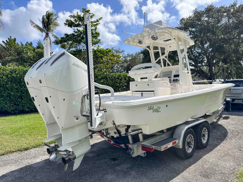 Slide: The Image of 2022 SeaVee 270Z boat on trailer, featuring dual outboard engines, parked outdoors. - 3