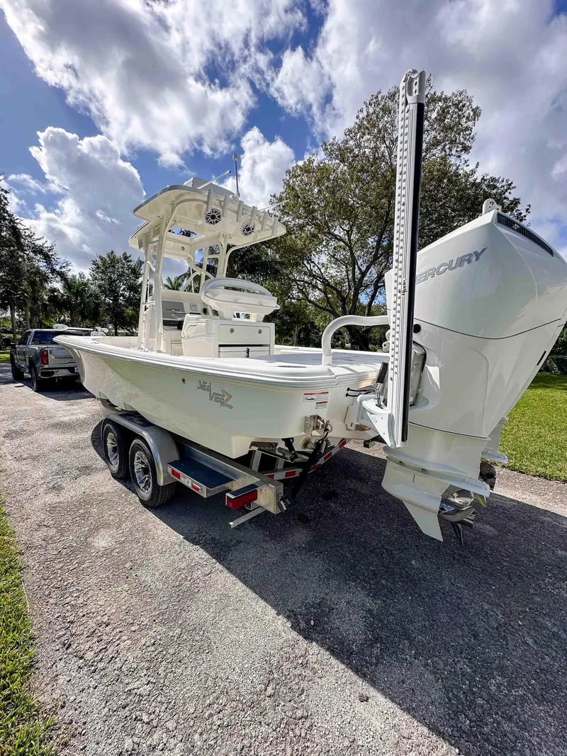 Slide: The Image of 2022 SeaVee 270Z boat on trailer, parked outdoors under a partly cloudy sky. - 35
