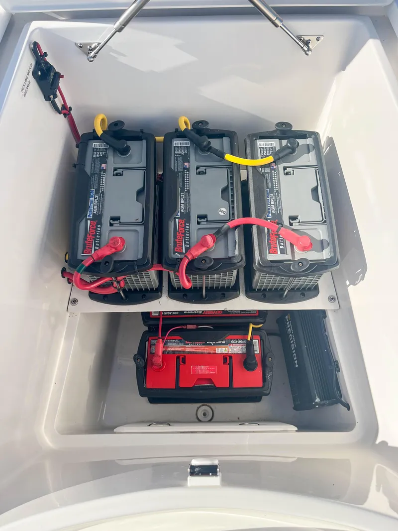 Slide: The Image of 2022 SeaVee 270Z boat battery compartment with four batteries neatly arranged. - 37