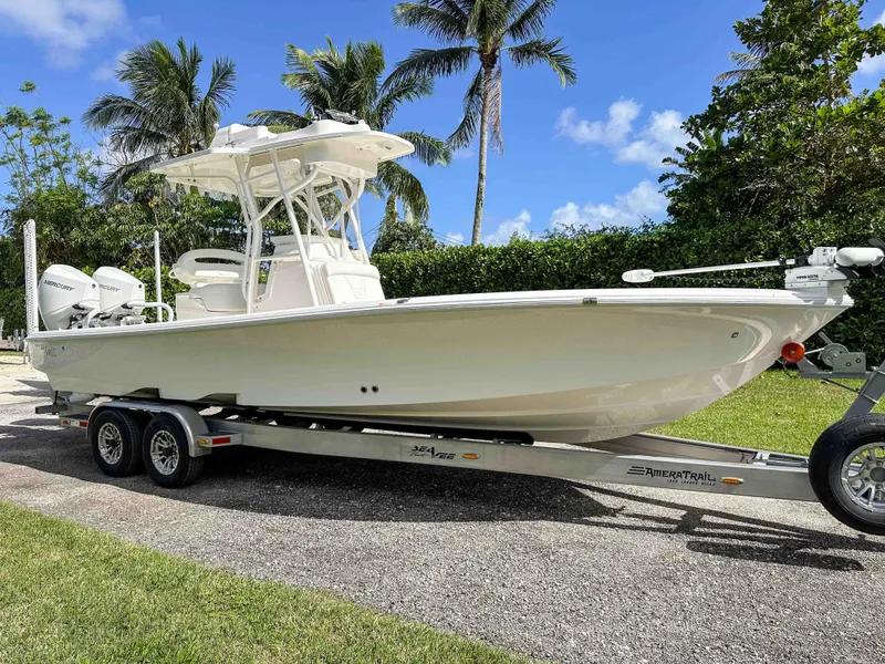 Slide: The Image of 2022 SeaVee 270Z boat on trailer, surrounded by palm trees and clear blue sky. - 4