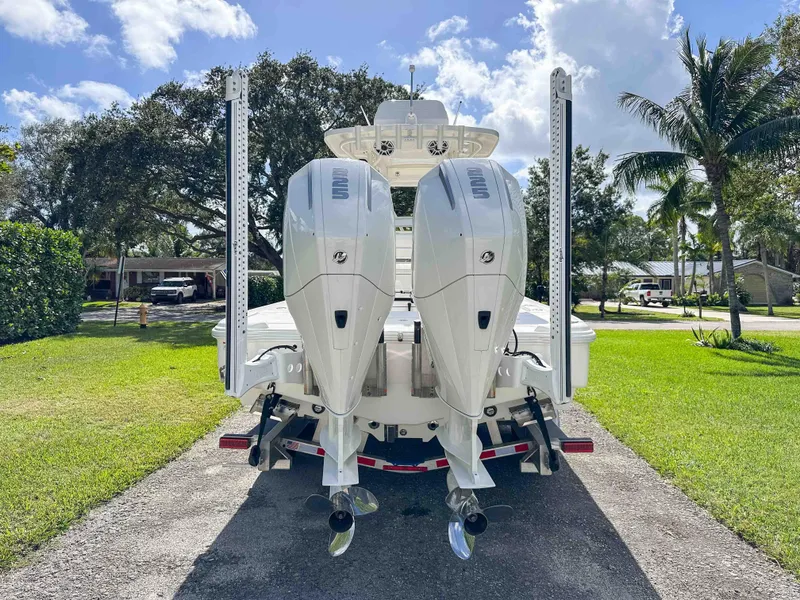 Slide: The Image of 2022 SeaVee 270Z boat with dual outboard motors, parked on a sunny driveway. - 6