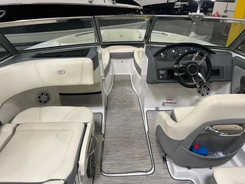 Slide: The Image of Interior of a 2022 Cobalt 220S boat with white seating and modern dashboard. - 2